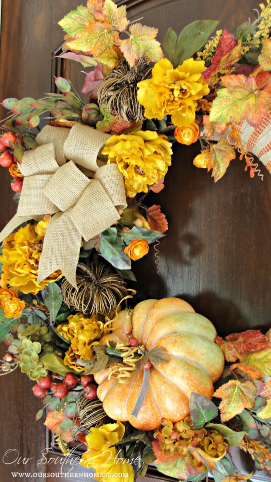 fall wreath with flowers, pumpkins and burlap ribbon