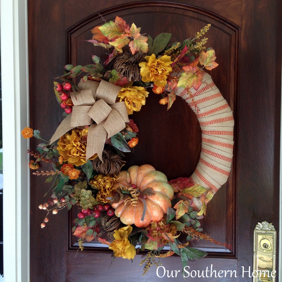 See how I took apart my old fall wreath that was in need of freshening up! I reused it to create a newup to date look for our Fall front entrance. Visit Our Southern Home for the details! #fall #falldecor #fallwreath