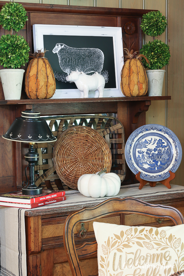 Blue and White Fall Tablescape mixed with green apples and orange pumpkins is a fun combination for a casual kitchen! #fallhome #falltablescape #falldecor #falldecorating #pumpkins #greenapples #frenchfarmhouse #frenchcountry #frenchfarmhouse #farmhousestyle 