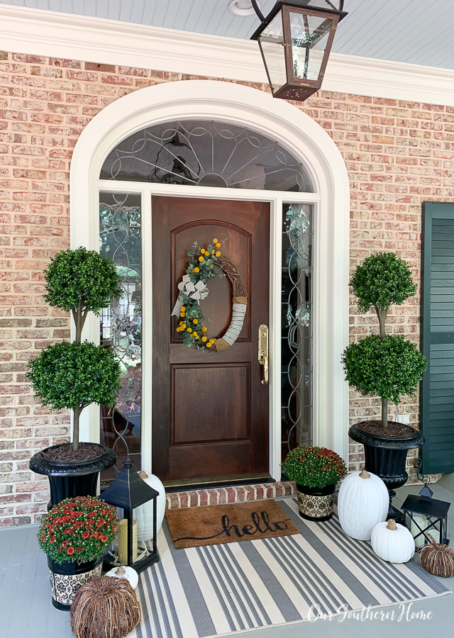 fall front porch with pumpkins