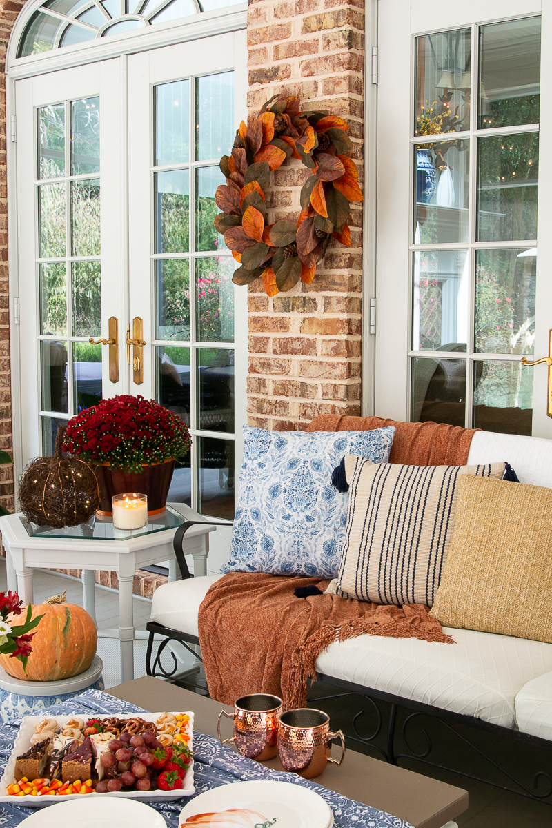 screened porch with fall decor