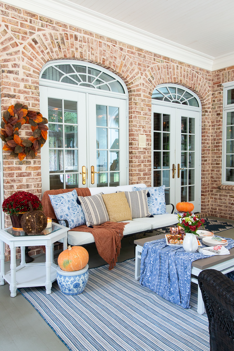 side view of a porch decorated for fall