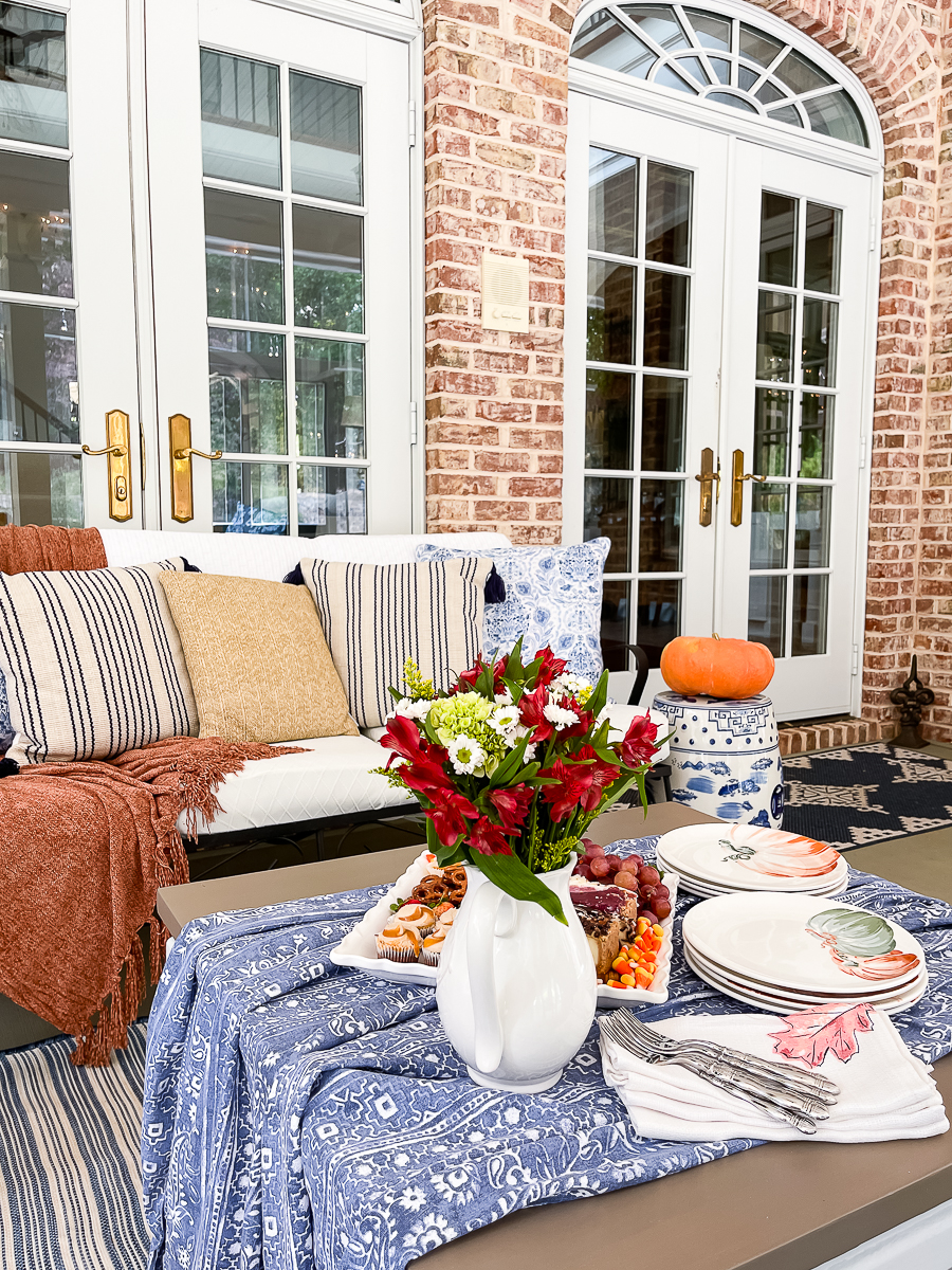 fall porch with pumpkins and mums