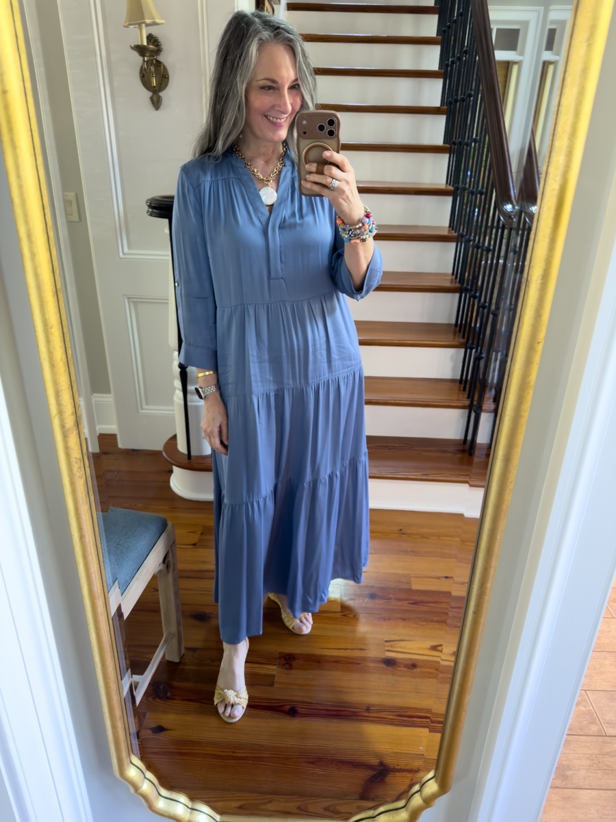 Woman wearing a blue tiered midi dress with gold sandals in mirror selfie