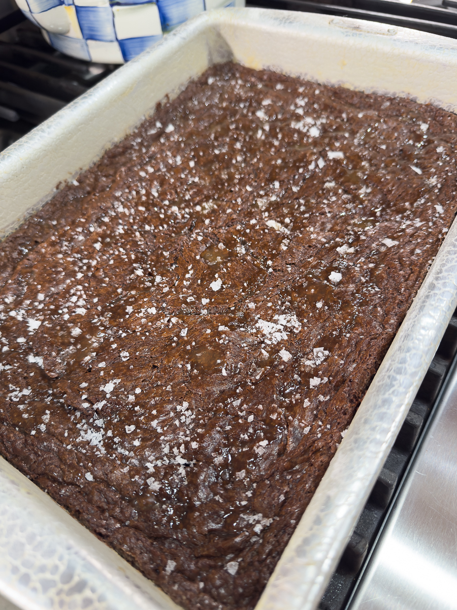 Pan of rich homemade brownies sprinkled with flaky sea salt.