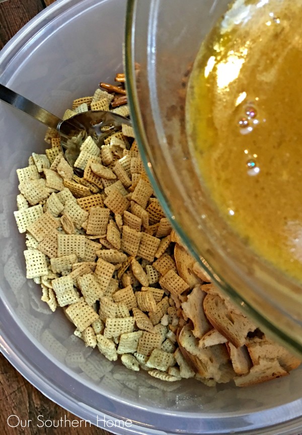 Pour the melted butter mixture over the cereal mixture and combine via Our Southern Home for your Chex Party Mix recipe #ad #mixexchangelove