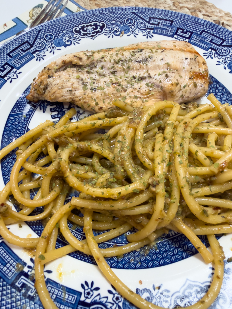 Chicken breast served with zucchini pasta on a blue and white transferware plate
