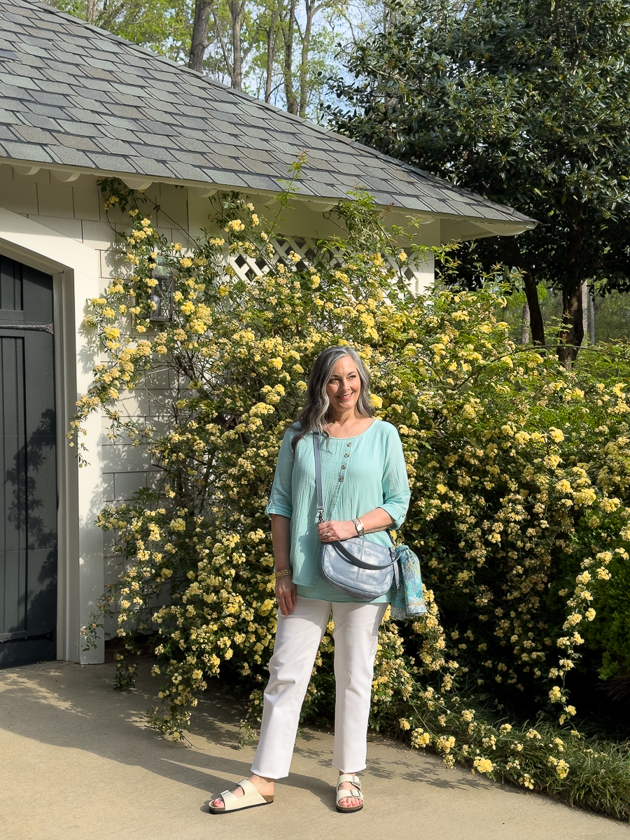 woman standing in front of roses