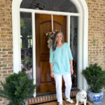 woman with dog on porch