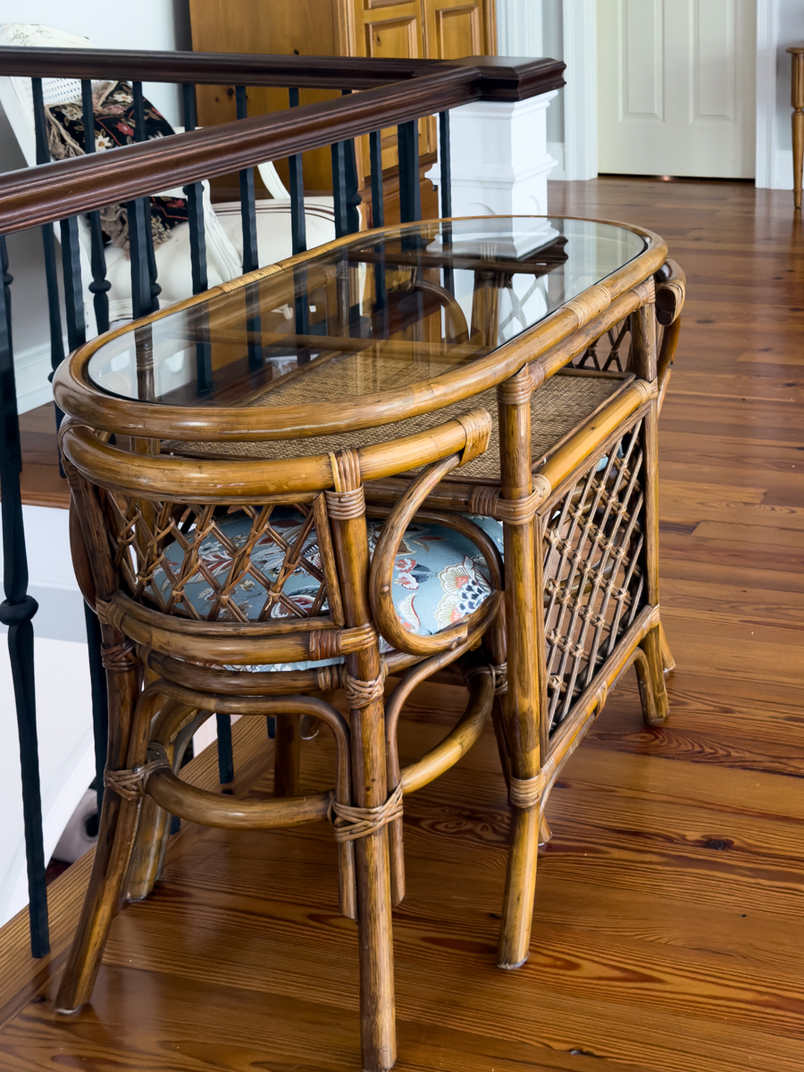 Rattan table and chairs with newly recovered blue floral seats in a traditional home.