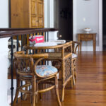 Rattan table and chairs with blue floral seats set up for a game of Rummikub.