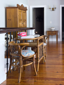 Rattan table and chairs with blue floral seats set up for a game of Rummikub.