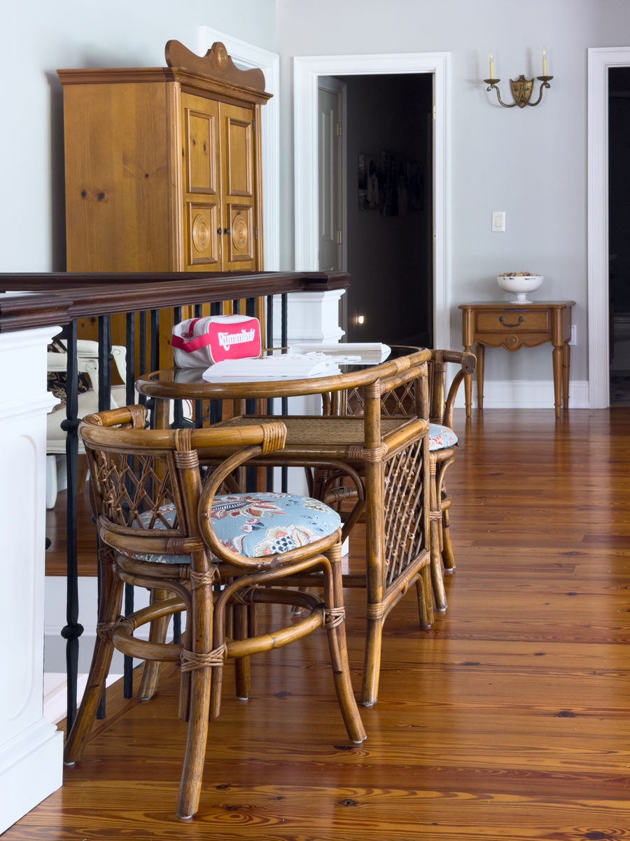 Rattan table and chairs with blue floral seats set up for a game of Rummikub.