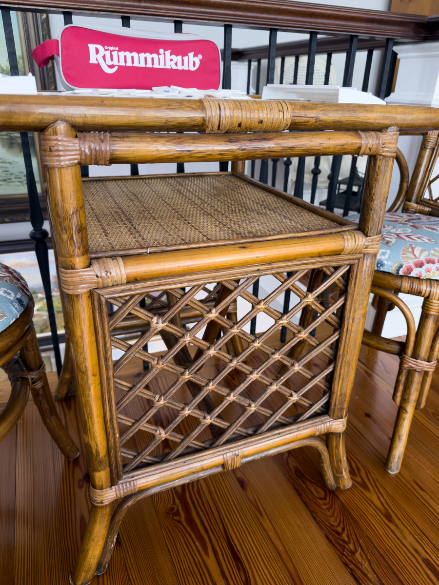 Close view of the woven shelf and lattice details on a warm brown rattan table.