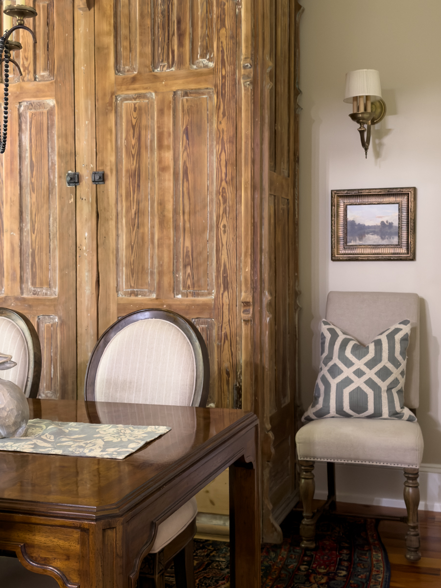 Traditional dining room with vintage furniture and European wall art