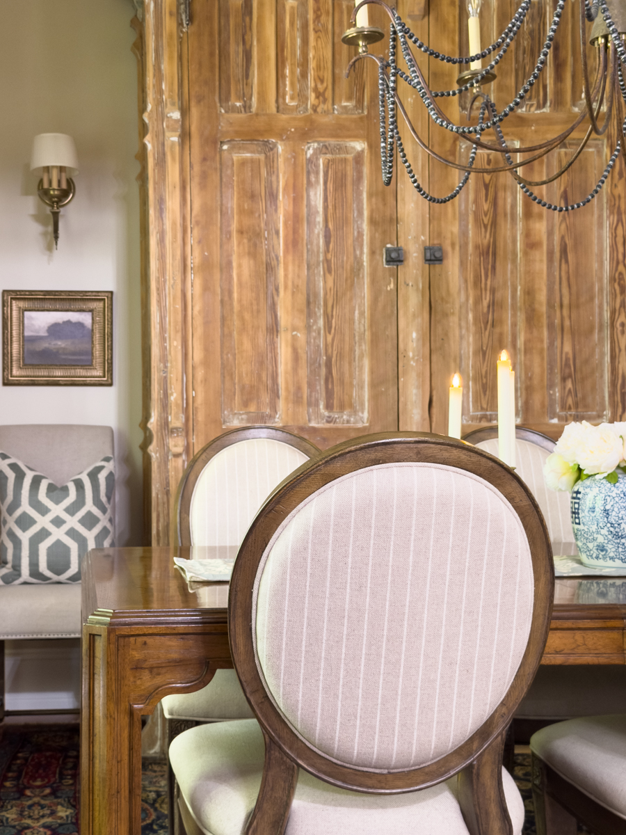 European-inspired dining room with vintage gold frame landscape art