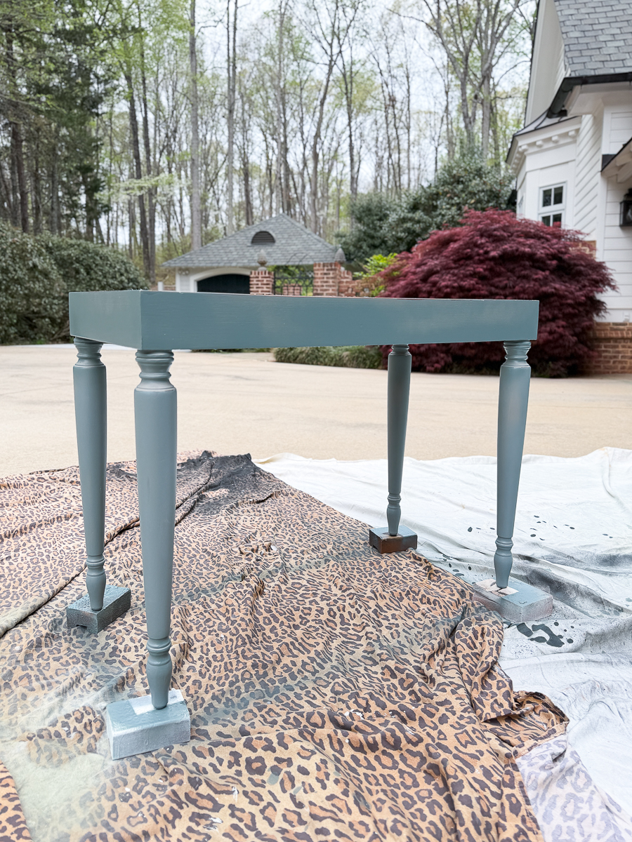 painted piano bench base drying after spray paint