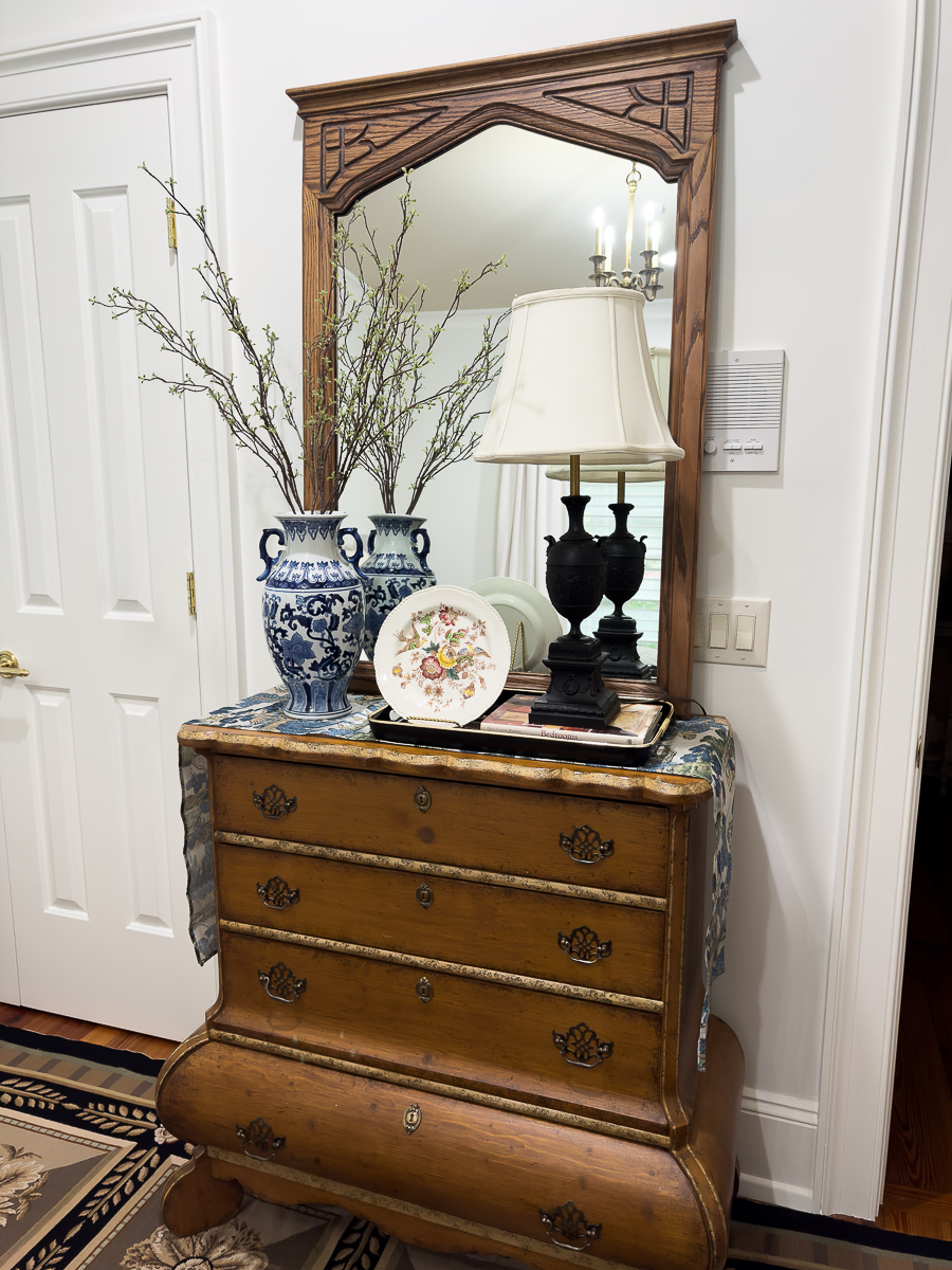 Vintage thrifted oak mirror after refinishing styled in bedroom