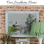 Thrift store needlework art become a showpiece on the screened porch with a new finish to the frame.