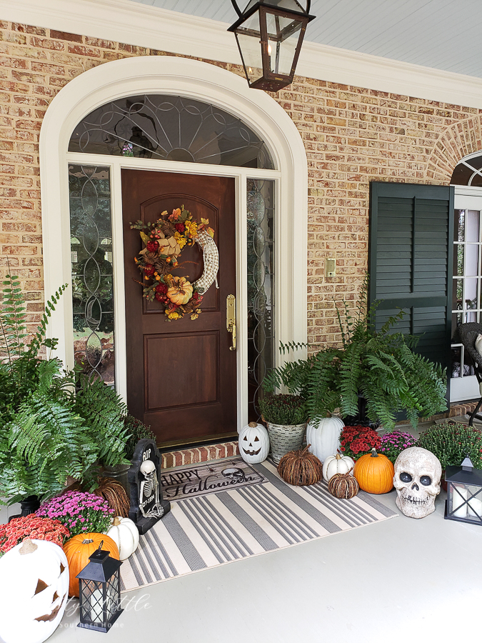 front door with mums and pumpkins