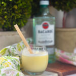 Creamy homemade piña colada made in an ice cream maker served in a cocktail glass.