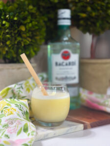 Creamy homemade piña colada made in an ice cream maker served in a cocktail glass.