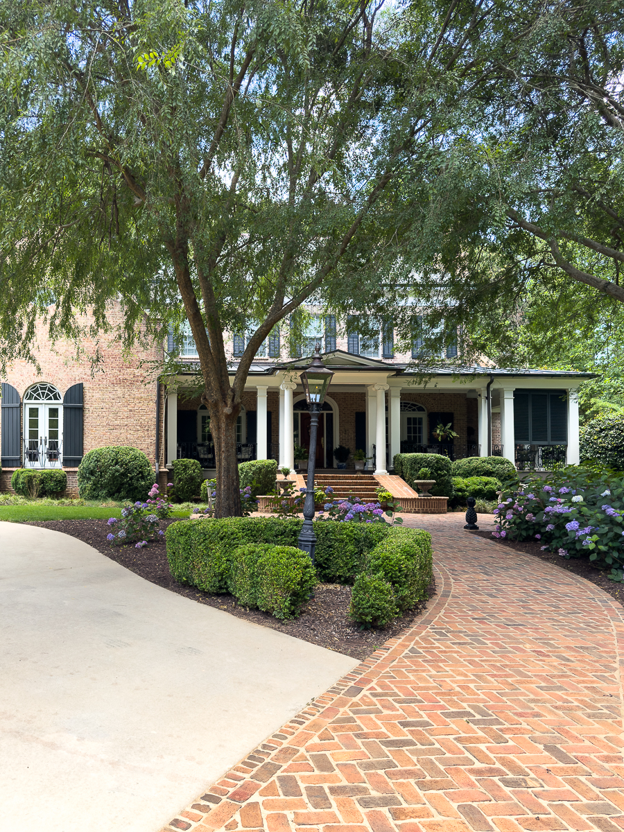 front of house with brick walk and hydrangeas