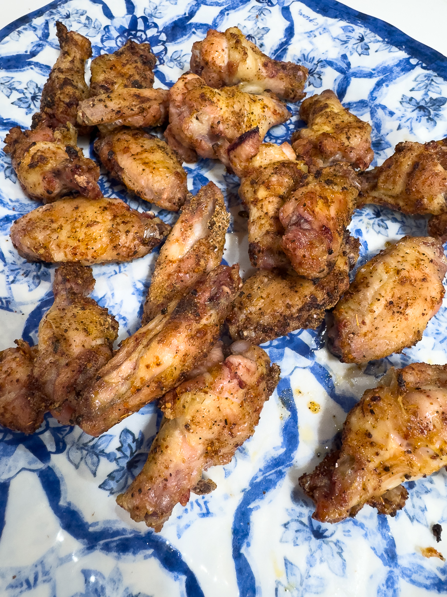 Plate of crispy smoked chicken wings seasoned with Tajín.