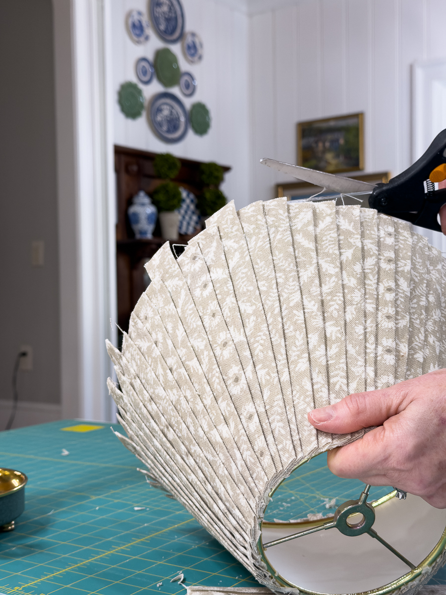cutting excess fabric off pleated shade