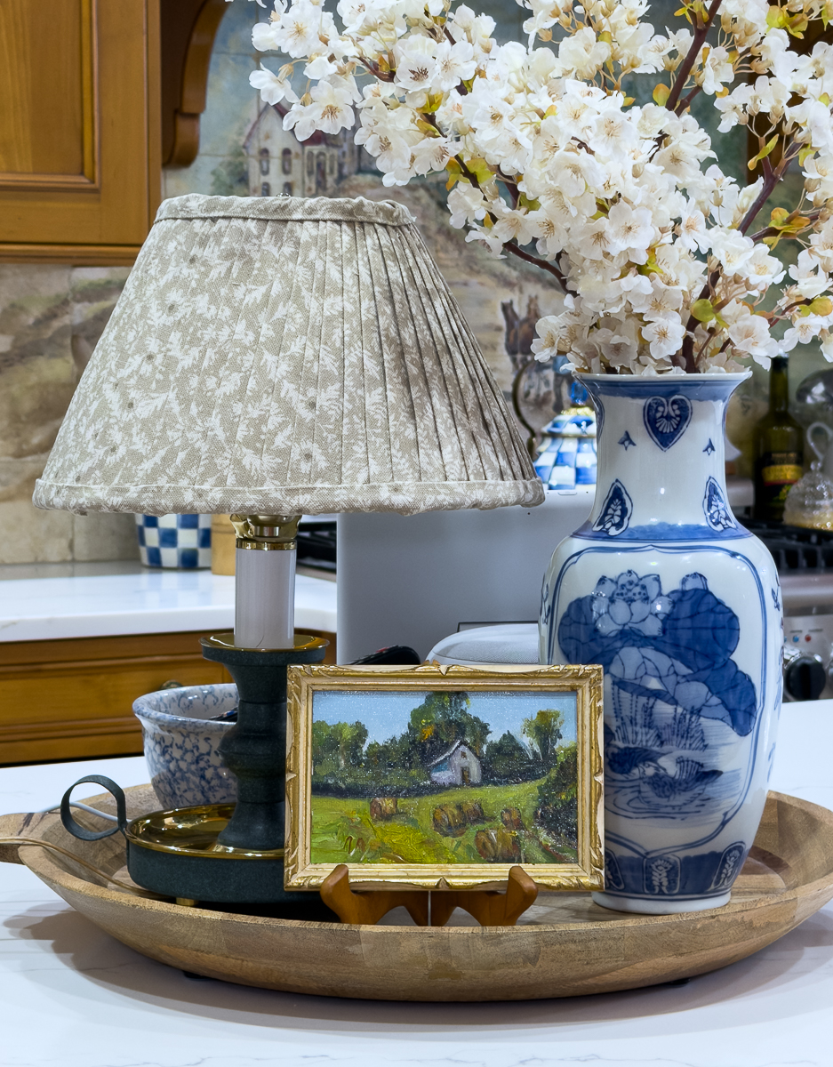 kitchen counter vignette with chinoiserie vase, lamp and wooden tray