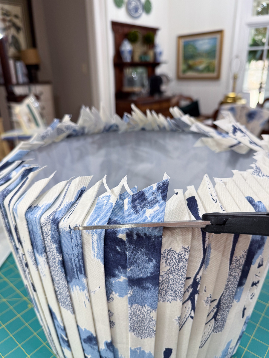 cutting off excess fabric from shade