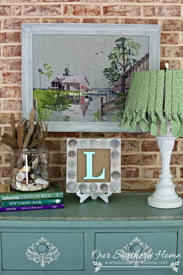 Thrift store needlework art become a showpiece on the screened porch with a new finish to the frame.