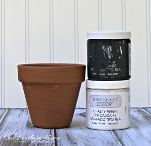 Make an inexpensive centerpiece by applying a weathered paint treatment to clay pots to create a striking topiary by Our Southern Home