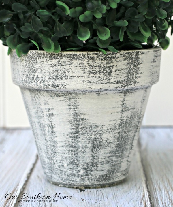Make an inexpensive centerpiece by applying  a weathered paint treatment to clay pots to create a striking topiary by Our Southern Home