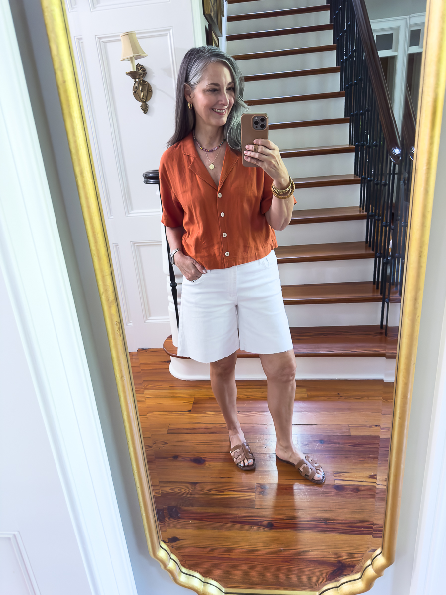 woman in white shorts and orange blouse