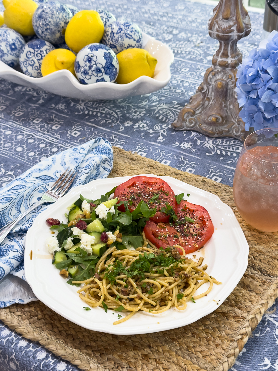 plate of pasta, salad and tomatoes