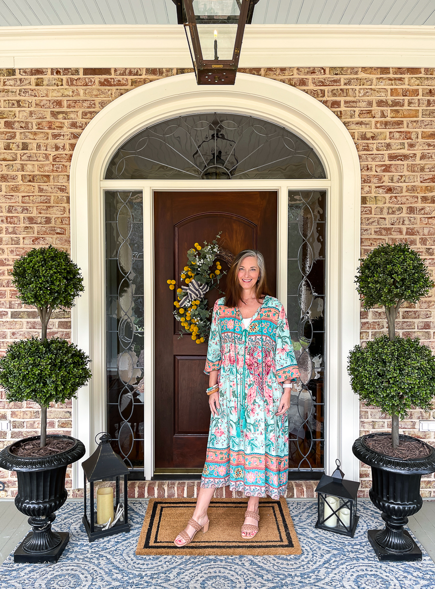 woman in floral dress on porch