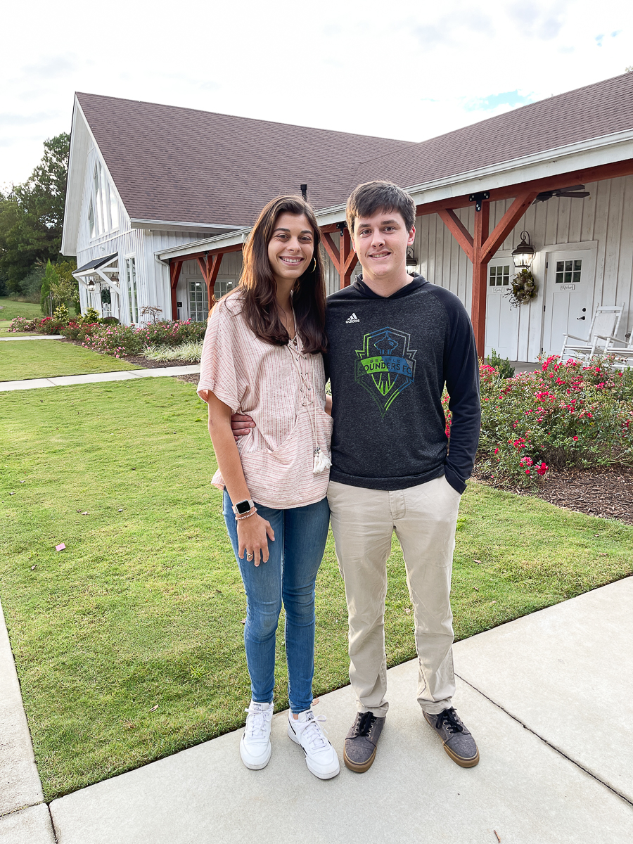 couple in front of white barn