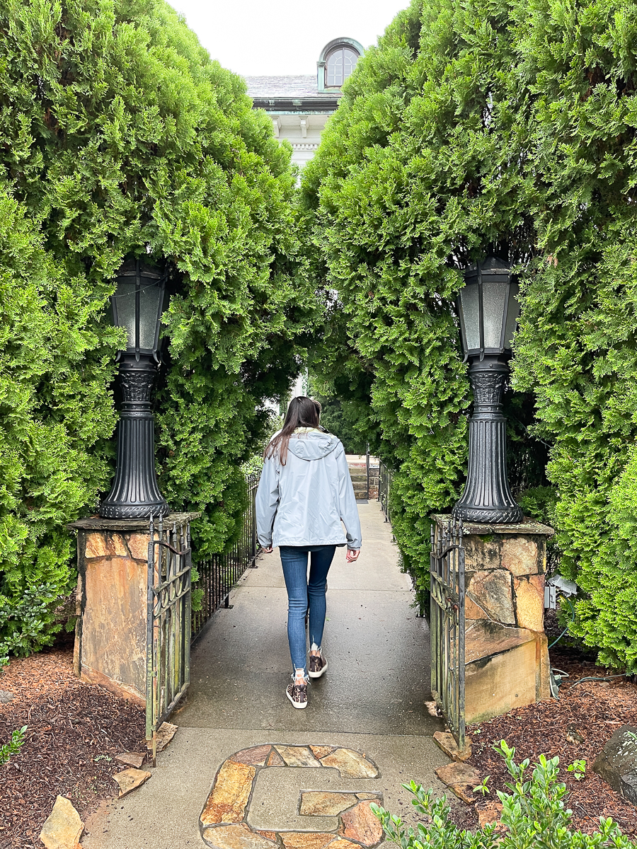 girl walking through shrubs