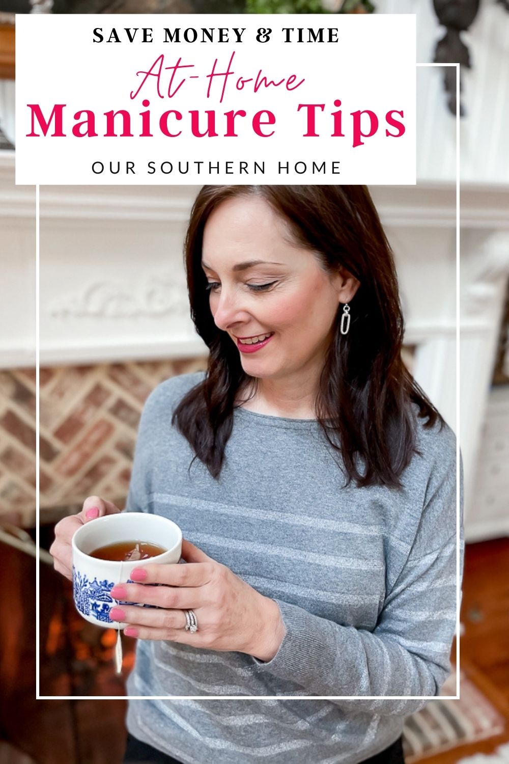 woman holding a cup of tea with pink manicure