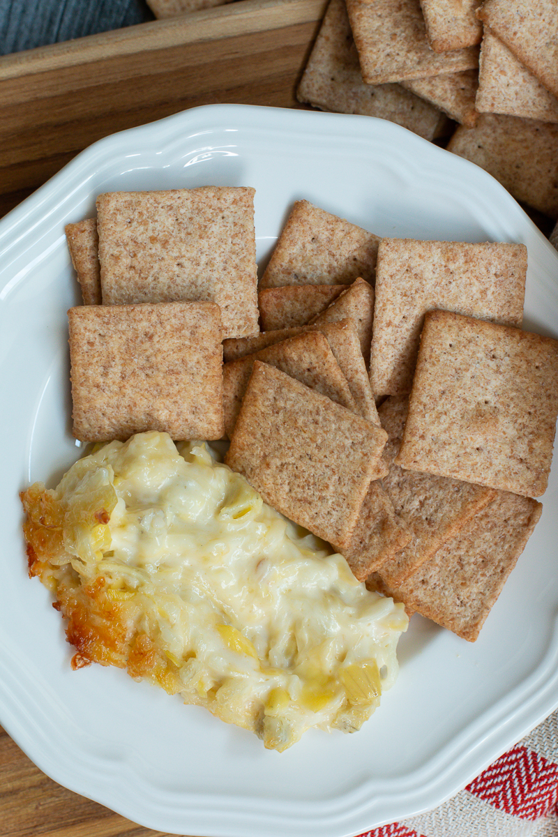 artichoke dip with crackers on plate