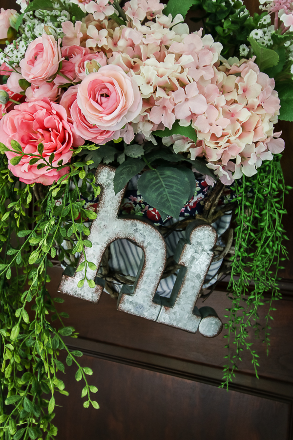 Cottage farmhouse style basket wreath is this month's thrift store makeover! Many ideas brought to you each month from the team! #thriftstore #makeover #wreath #basketwreath #frontdoor