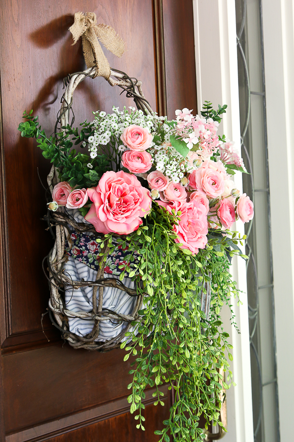 Cottage farmhouse style basket wreath is this month's thrift store makeover! Many ideas brought to you each month from the team! #thriftstore #makeover #wreath #basketwreath #frontdoor