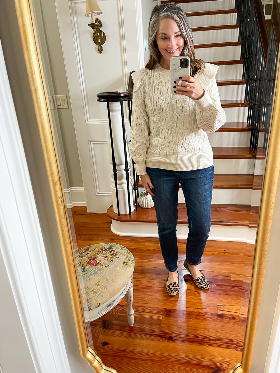 mirror selfie in a tan sweater with ruffles