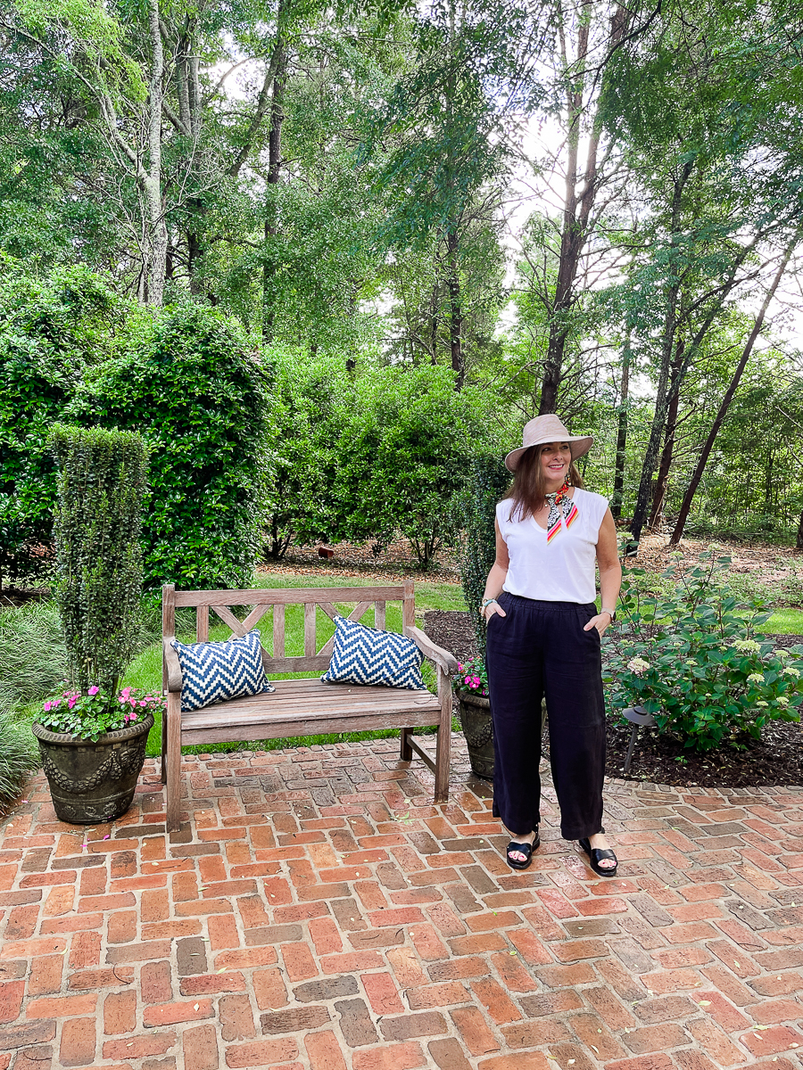 woman on patio in a hat