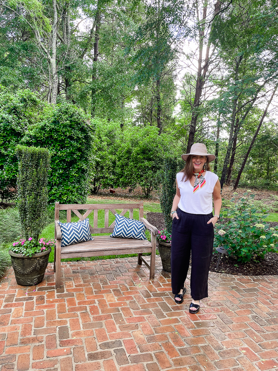 woman standing on patio in hat