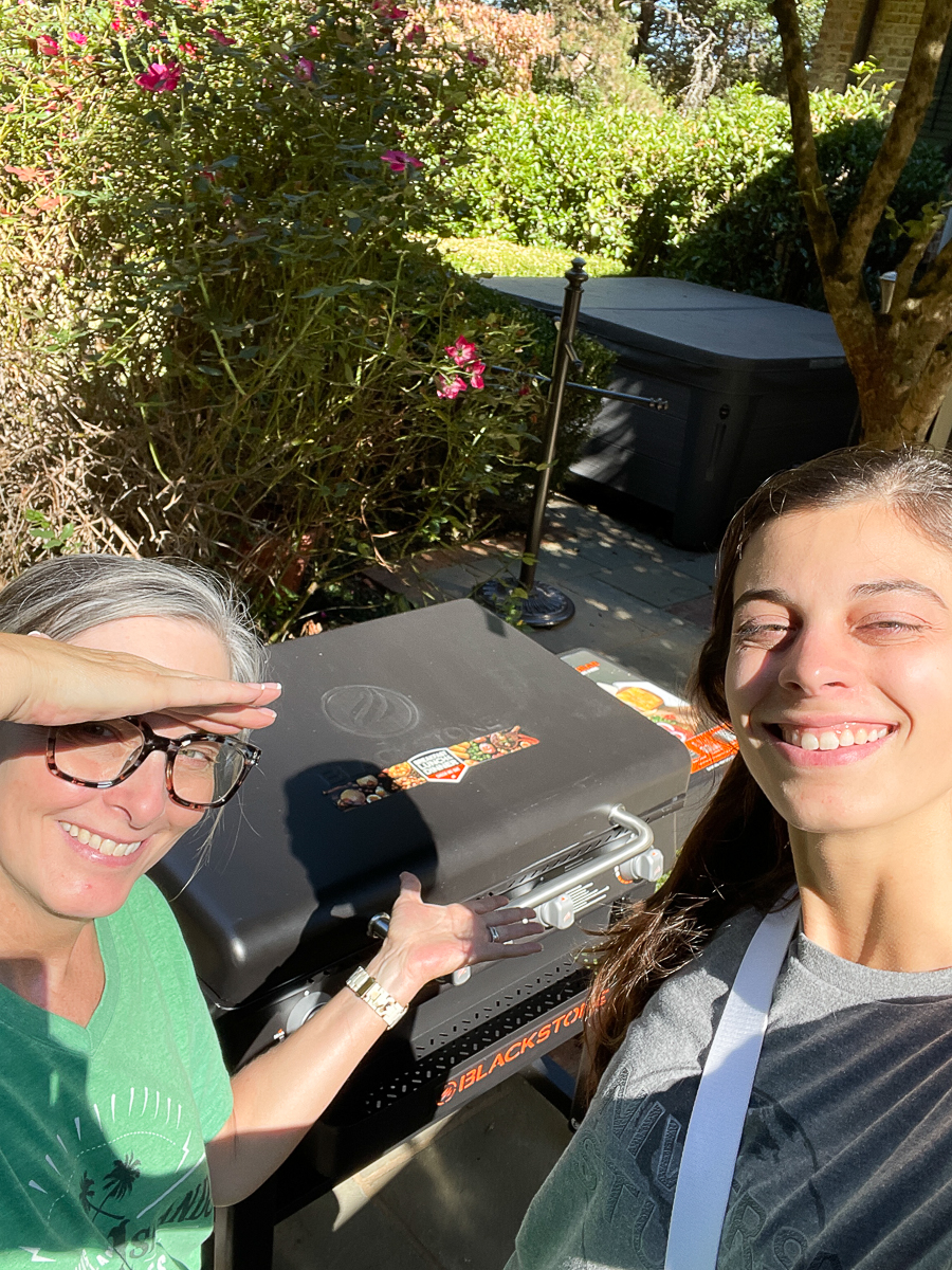 mother and daughter in from of blackstone grill