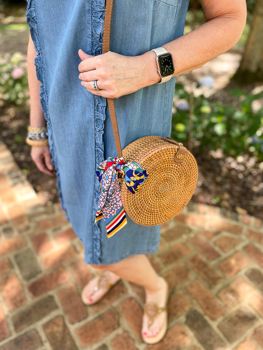 woman holding a wicker purse