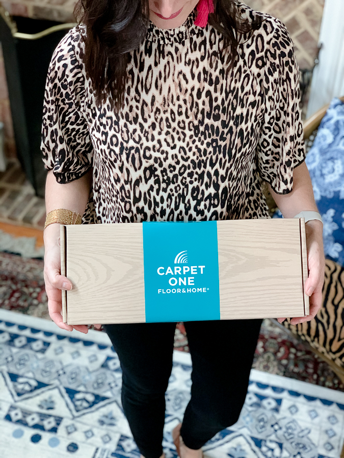 girl holding a box of carpet one samples