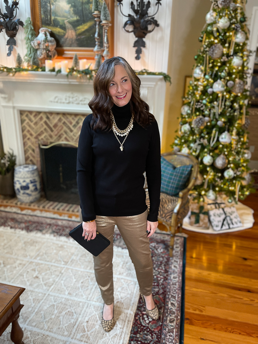 woman in gold pants and black sweater